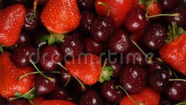 新鲜，成熟，多汁的樱桃和草莓背景，关闭浆果，旋转循环。 食物背景。 胃药